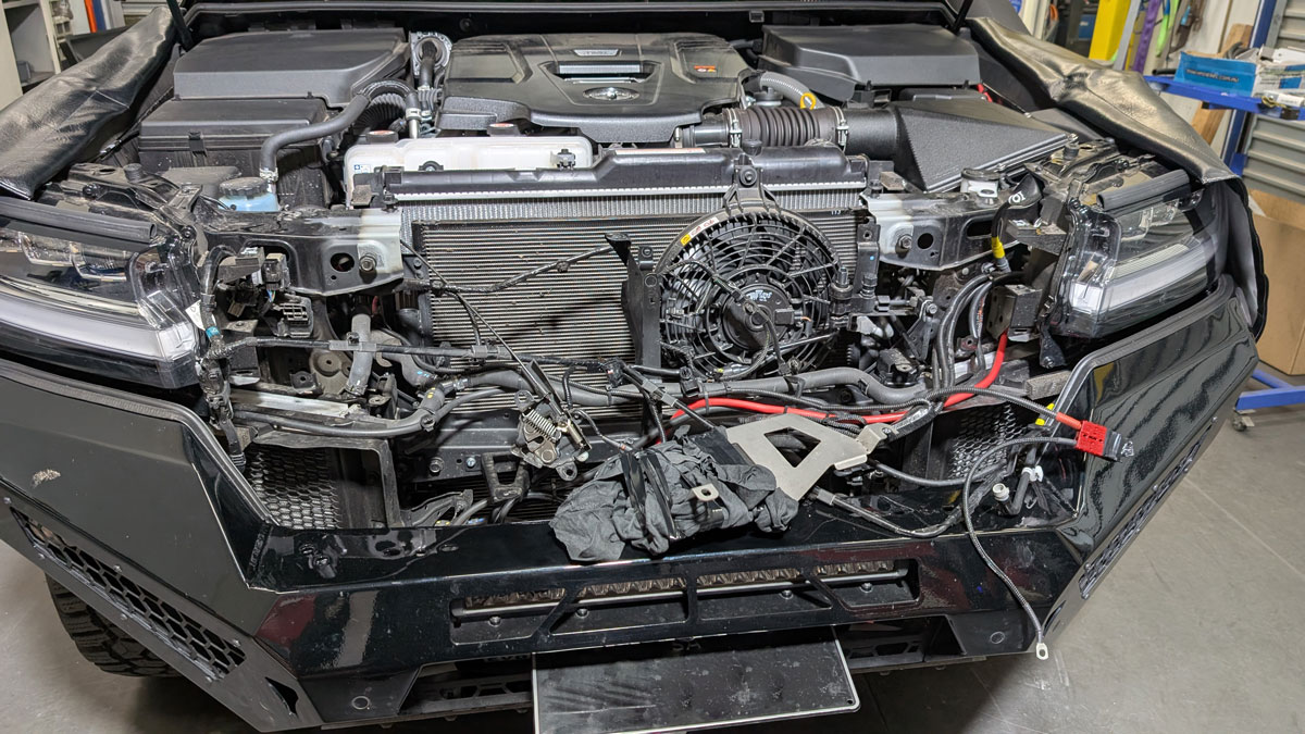 Under the bonnet of 2025 Toyota Landcruiser 300 Series showing fan for the condenser